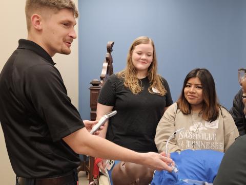 EMS worker gives demonstration to students